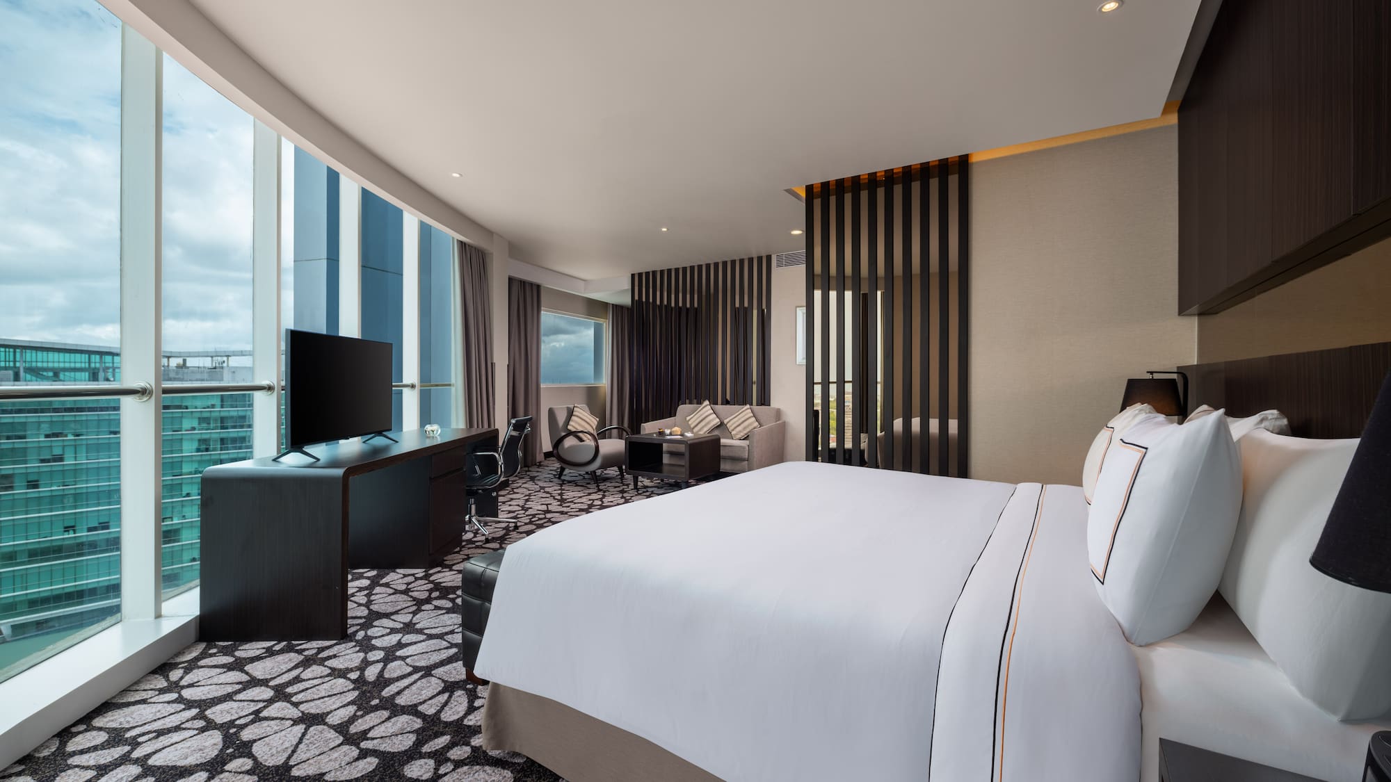 a room with a large bed and a television