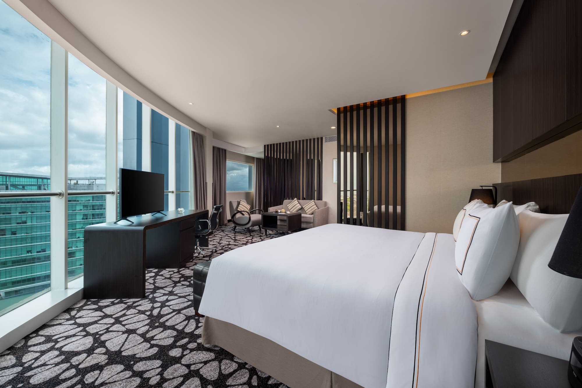 a room with a large bed and a television