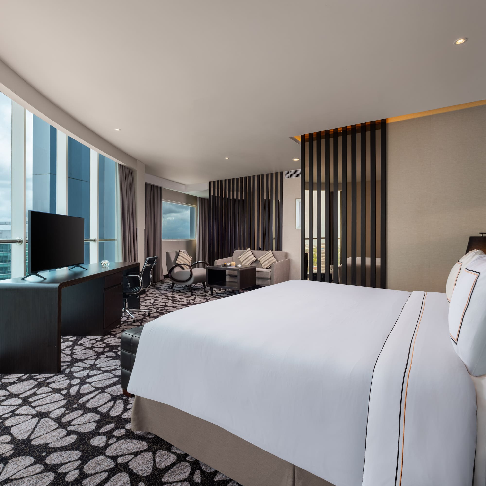 a room with a large bed and a television