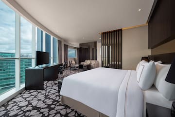 a room with a large bed and a television