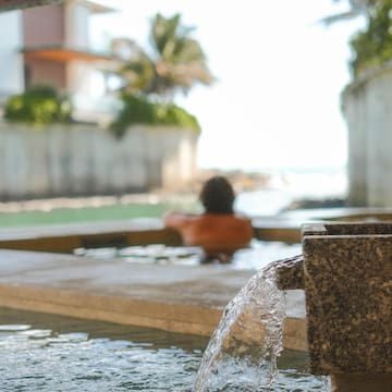 a person in a pool with water coming out of it