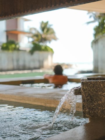 a person in a pool with water coming out of it