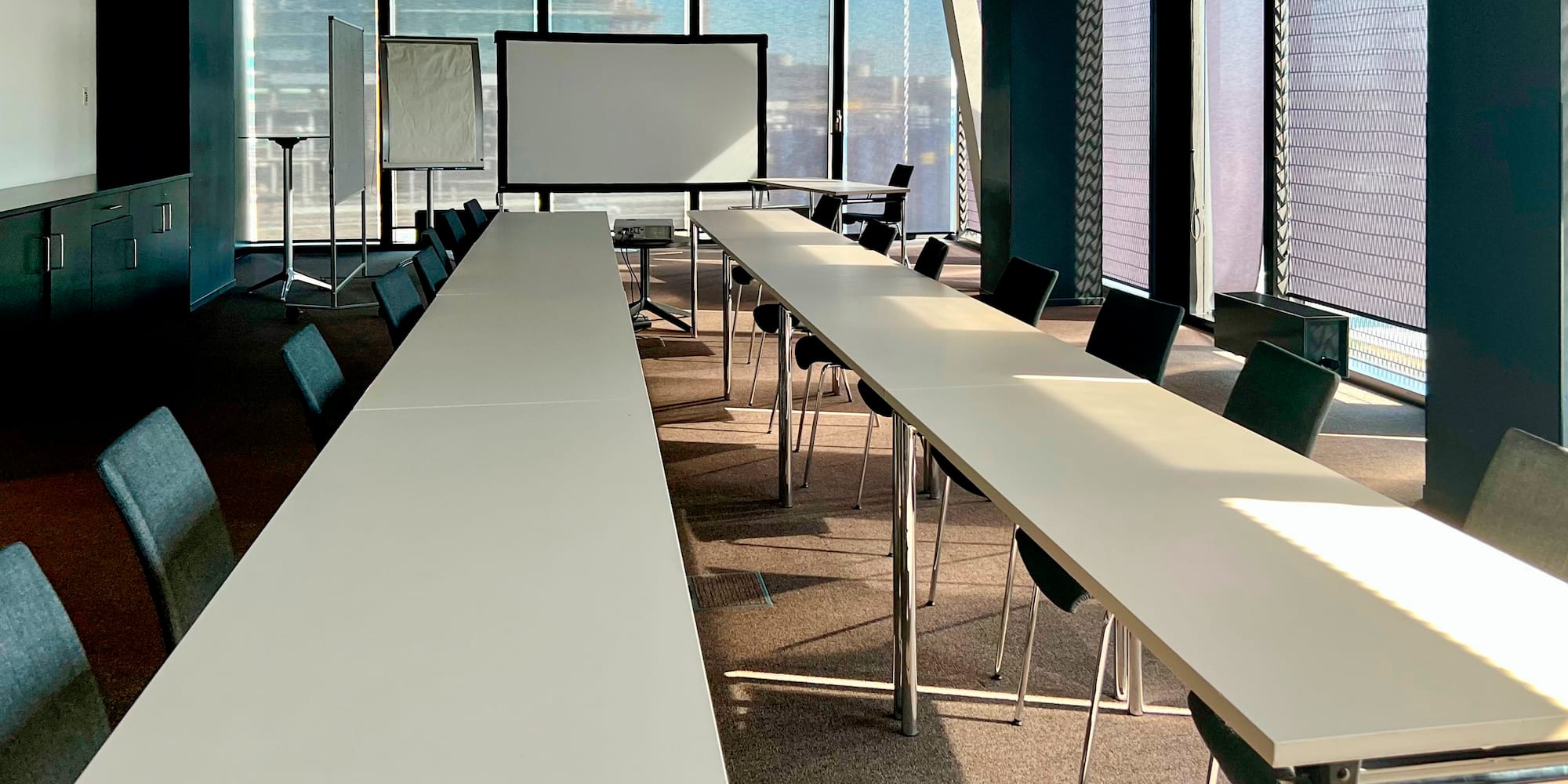 a room with long tables and chairs