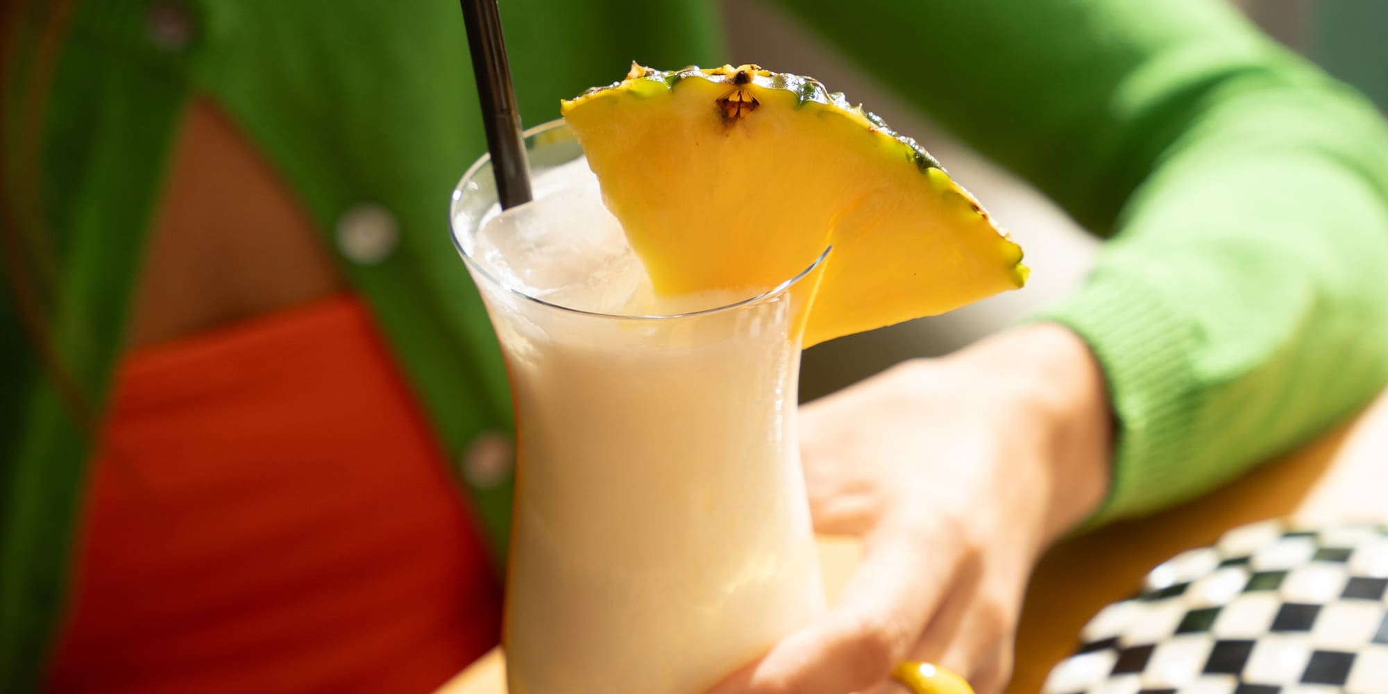 a woman holding a drink