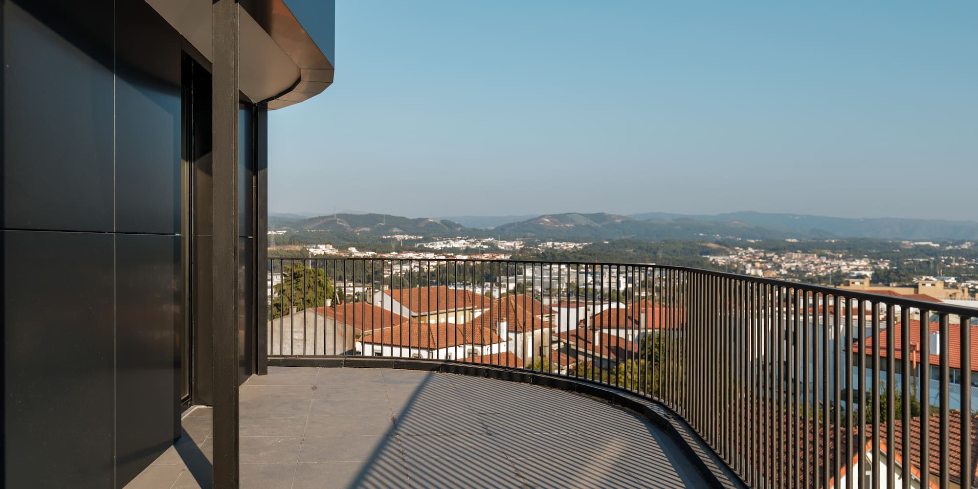 a balcony with a railing overlooking a city