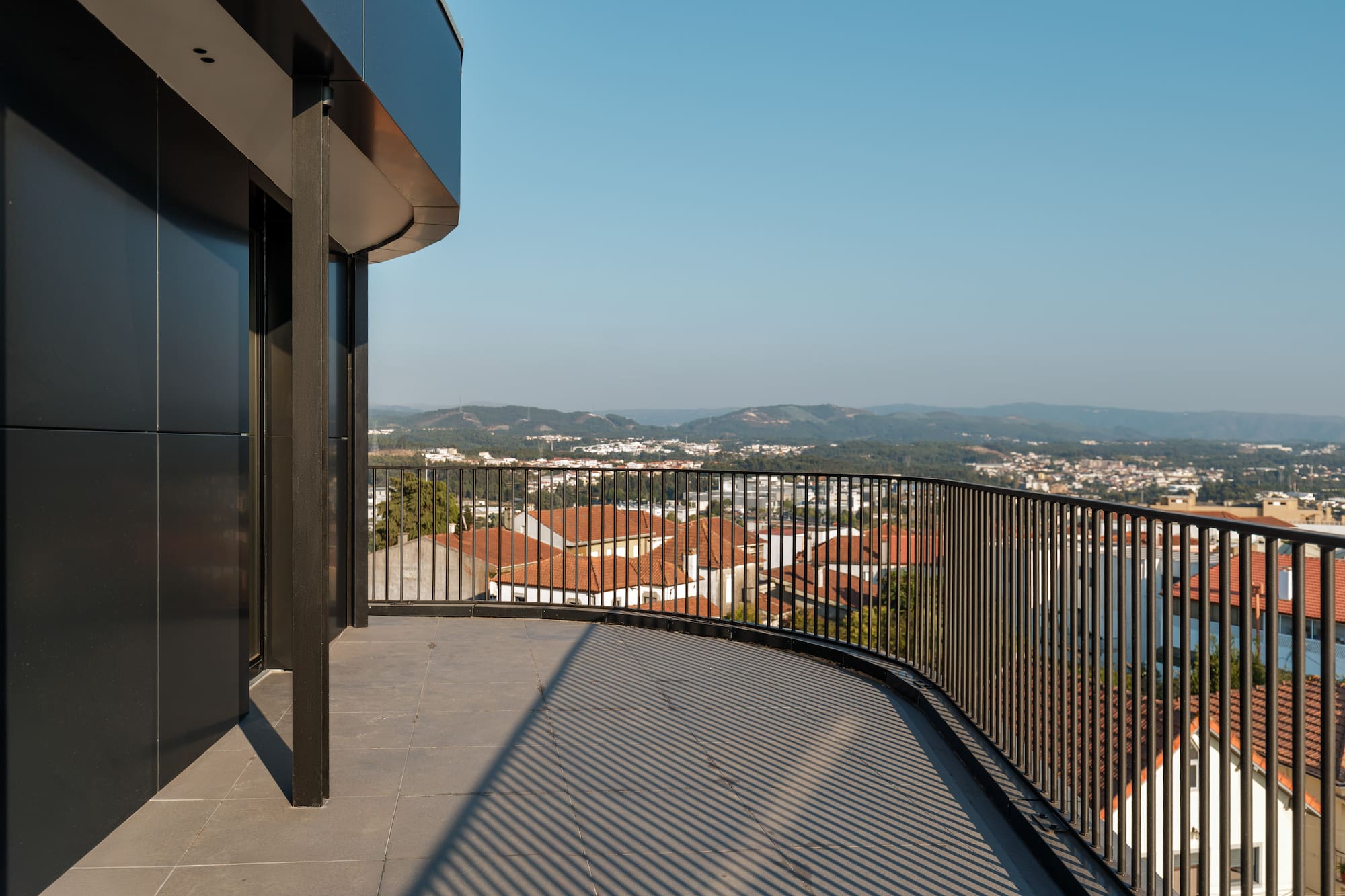 a balcony with a railing overlooking a city