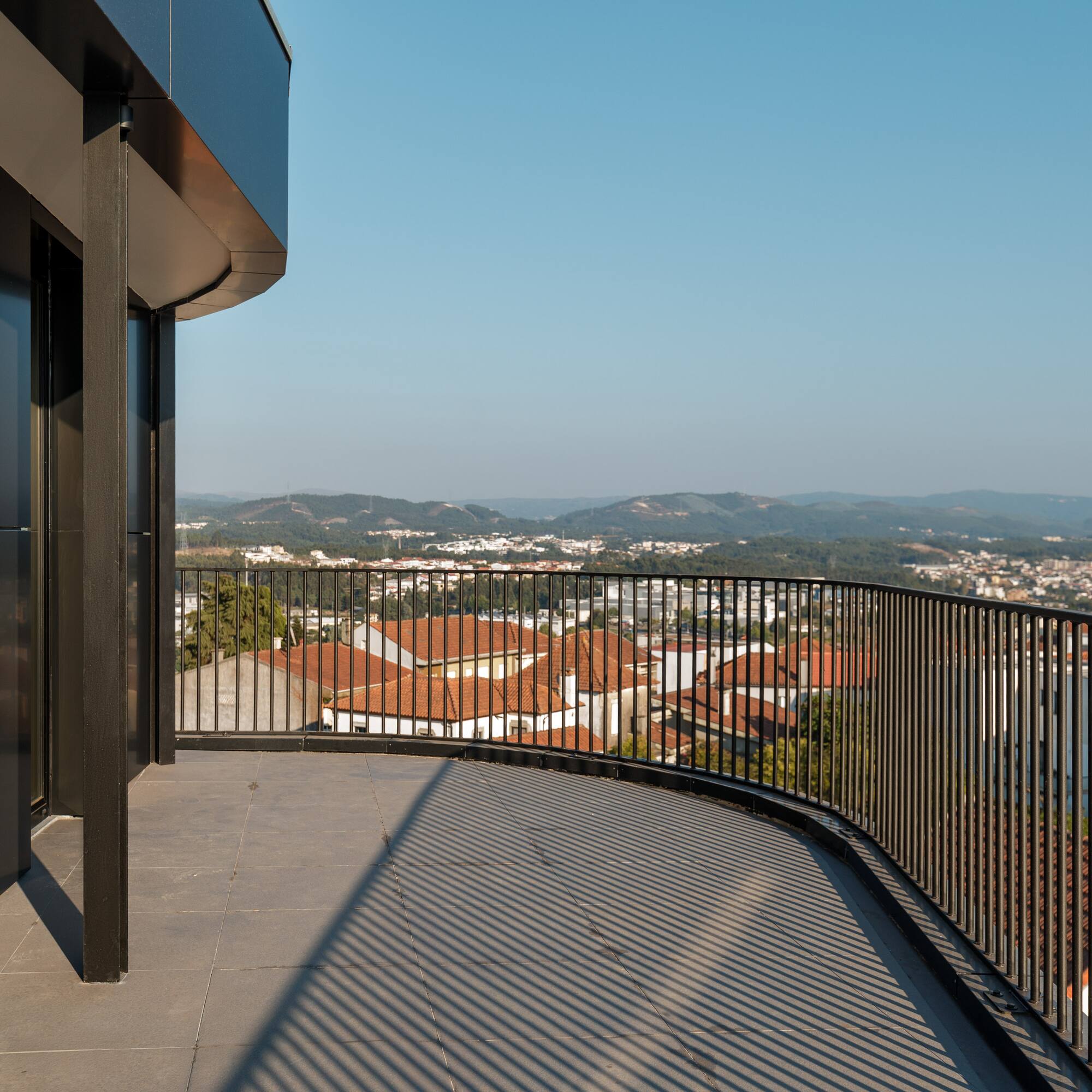 a balcony with a railing overlooking a city