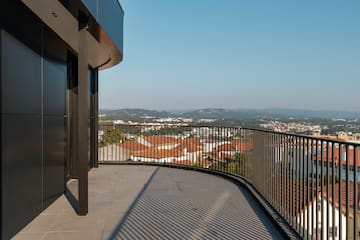 a balcony with a railing overlooking a city