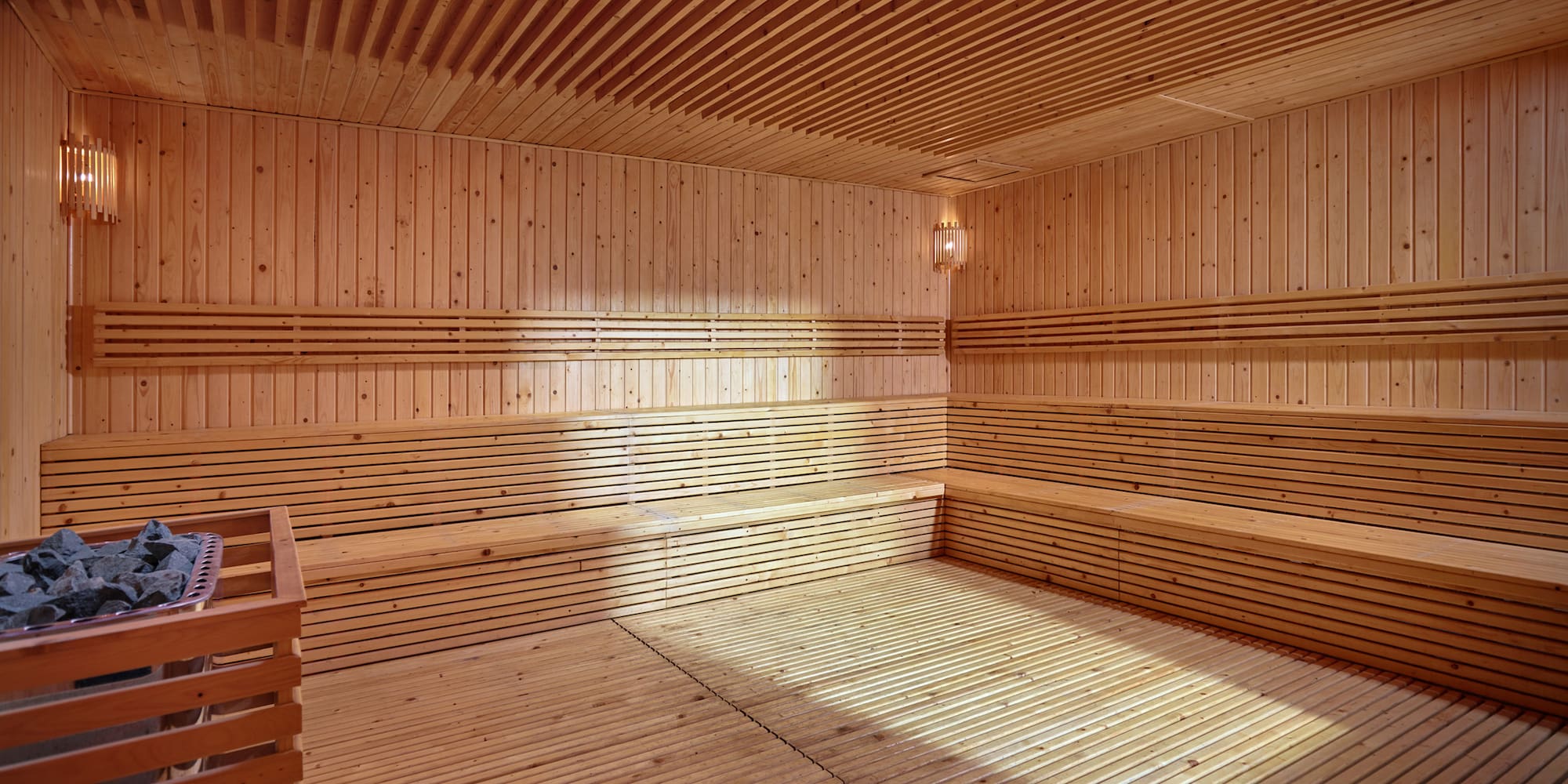 a wooden sauna with a light shining on the ceiling