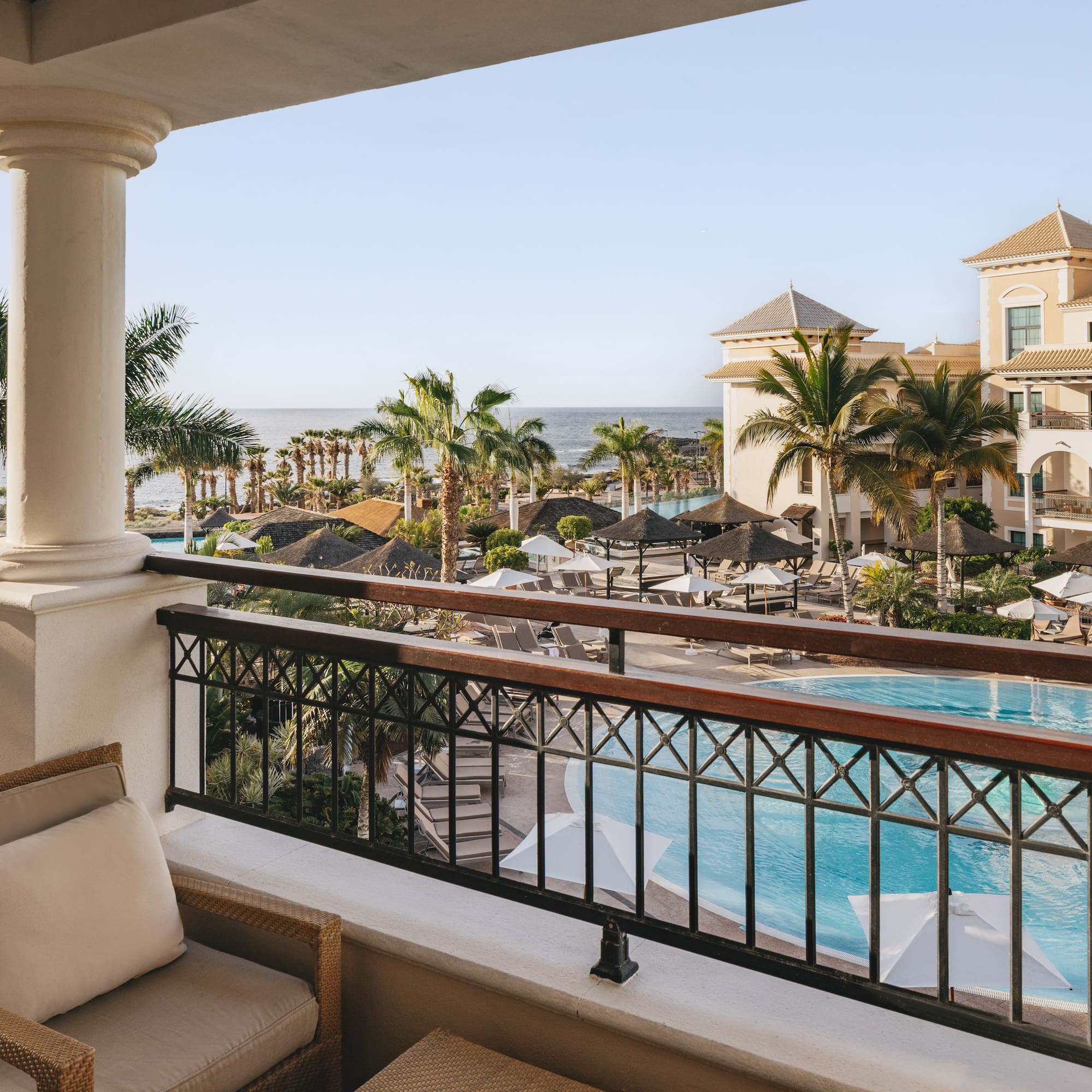 a balcony with a pool and chairs