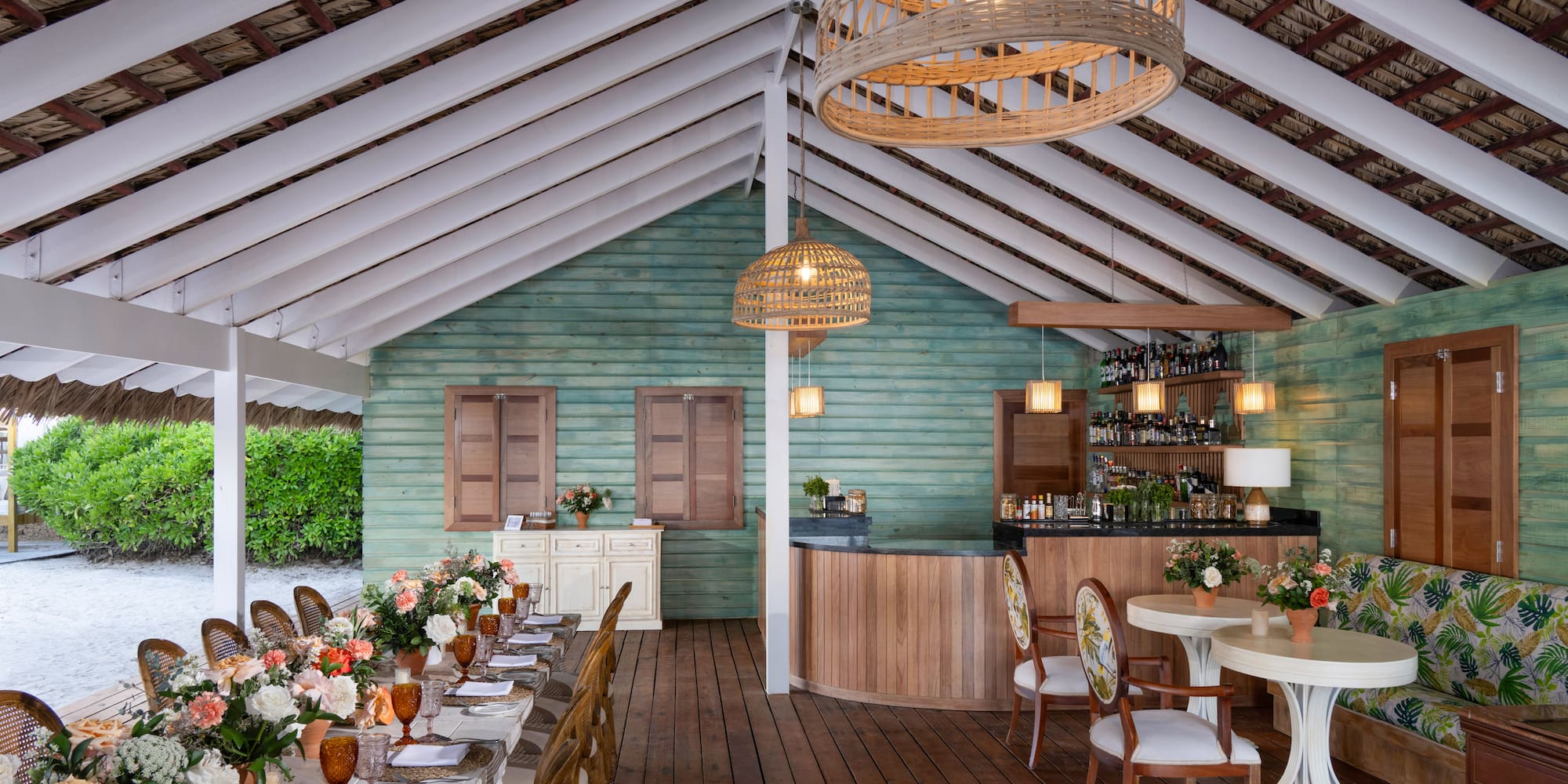 a room with tables and chairs and a bar