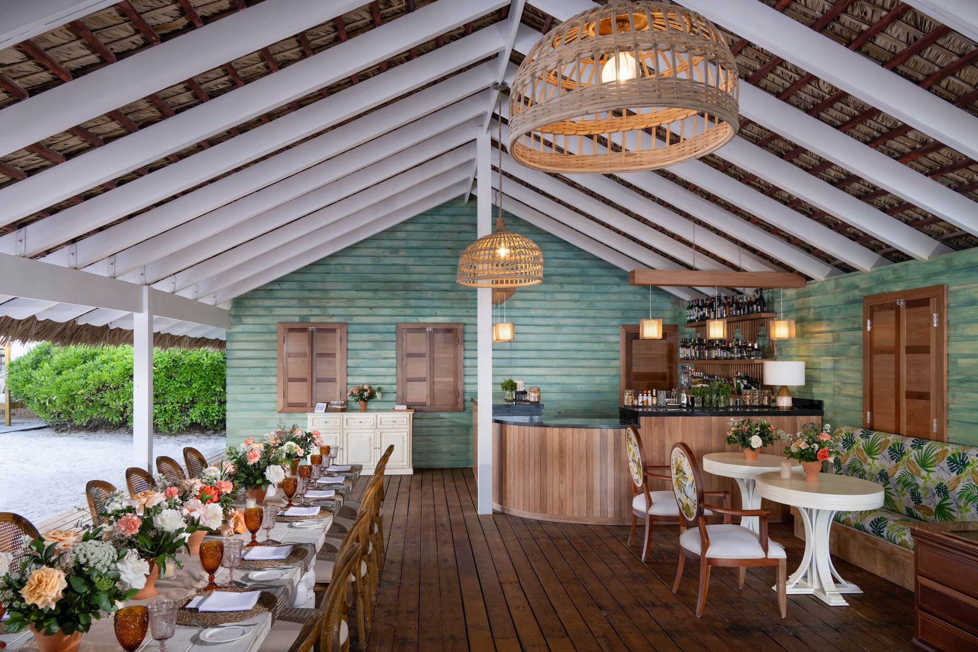 a room with tables and chairs and a bar