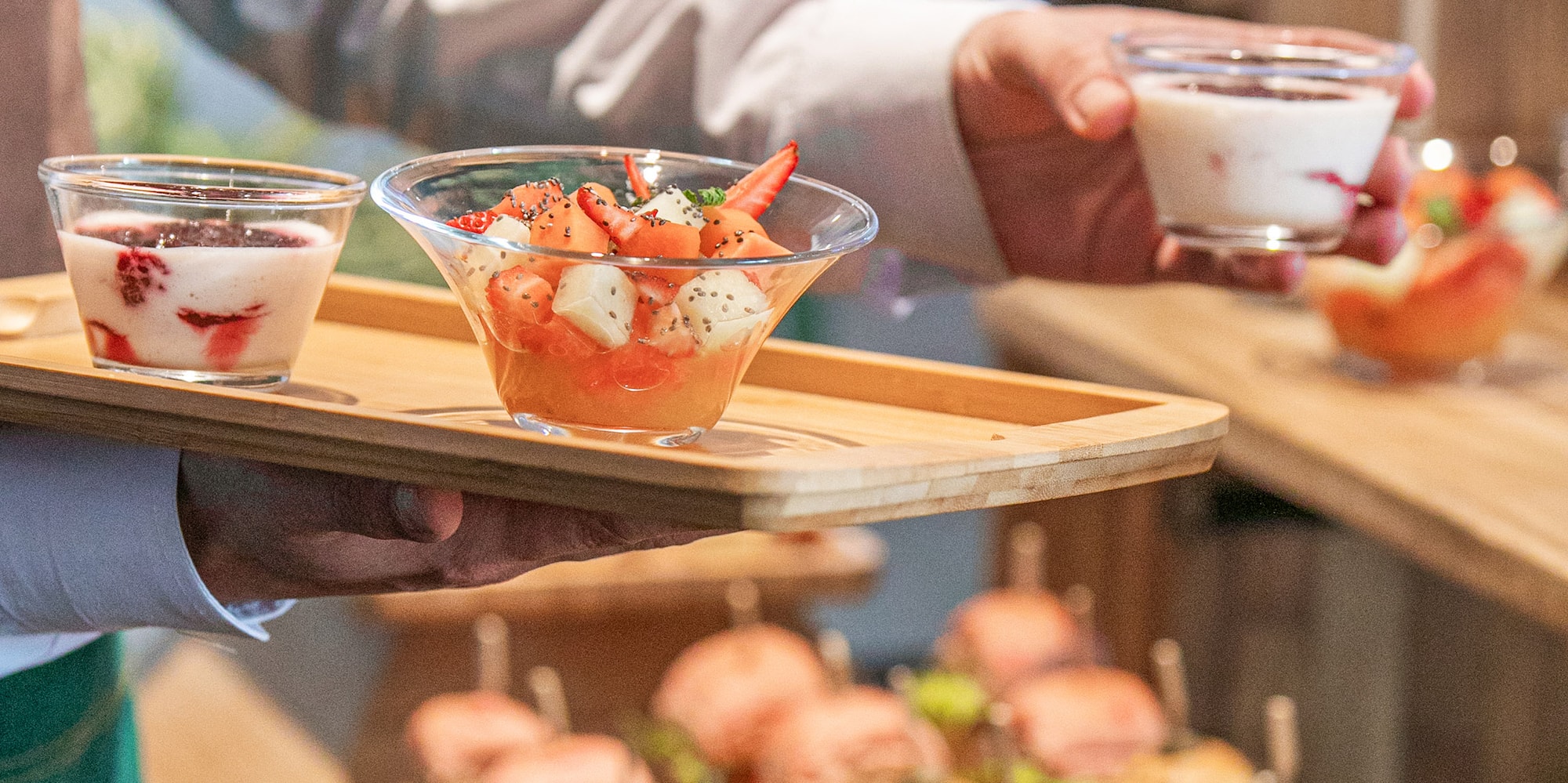 a person holding a tray of food