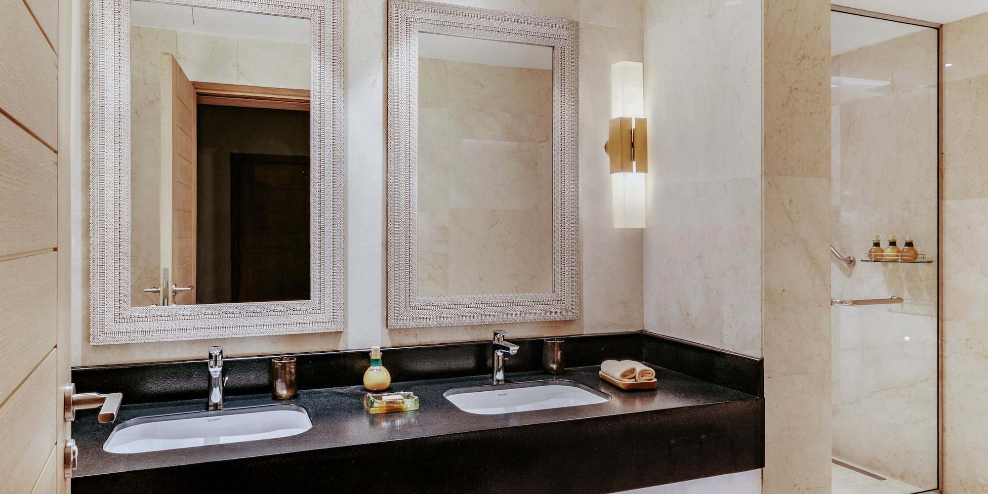 a bathroom with two sinks and mirrors