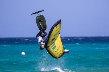 a person doing a flip on a surfboard