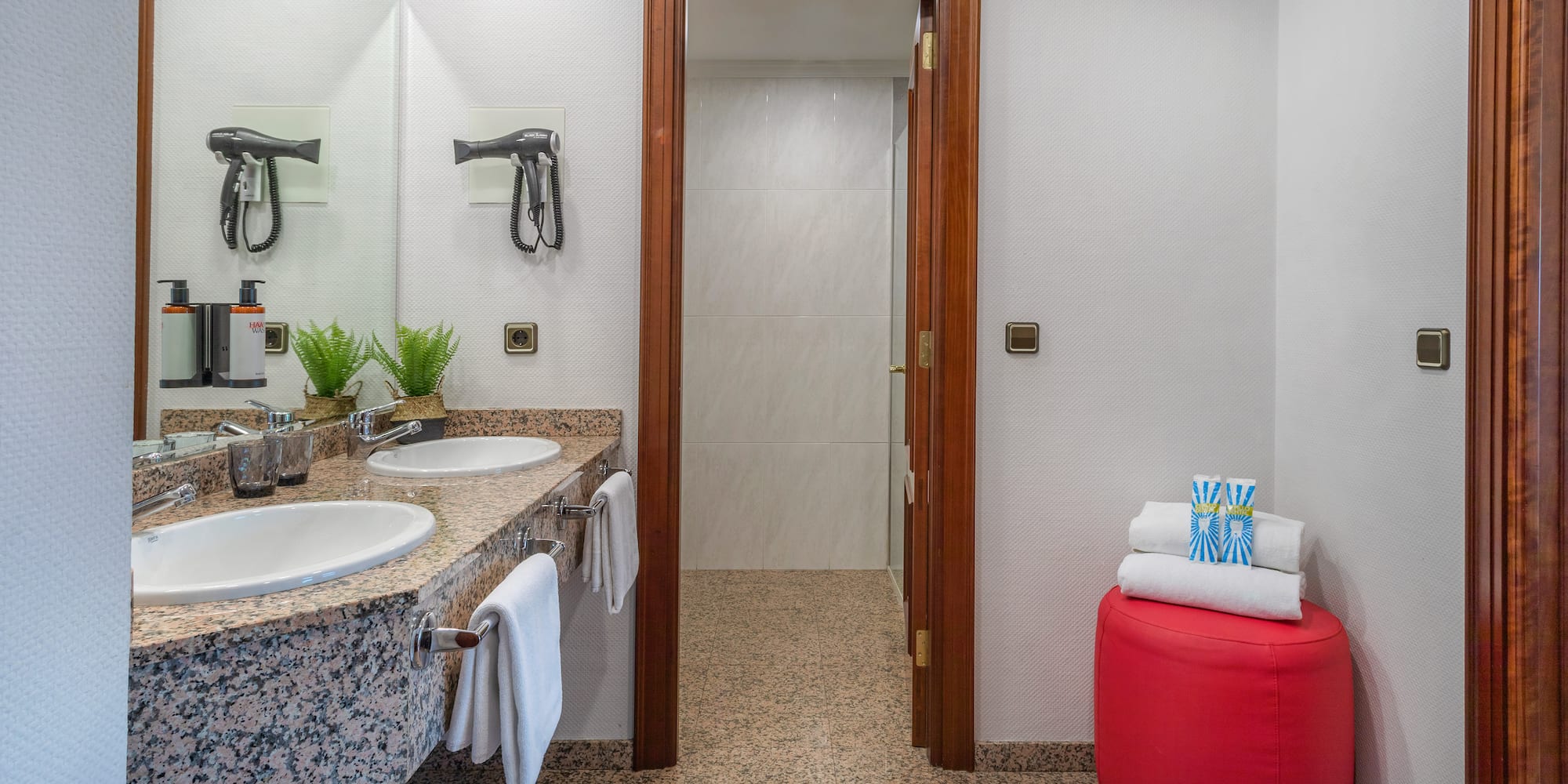 a bathroom with marble countertops and sinks