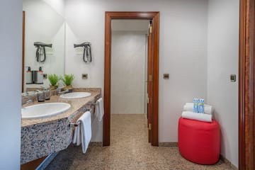 a bathroom with marble countertops and sinks