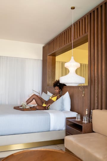 a woman in a garment lying on a bed