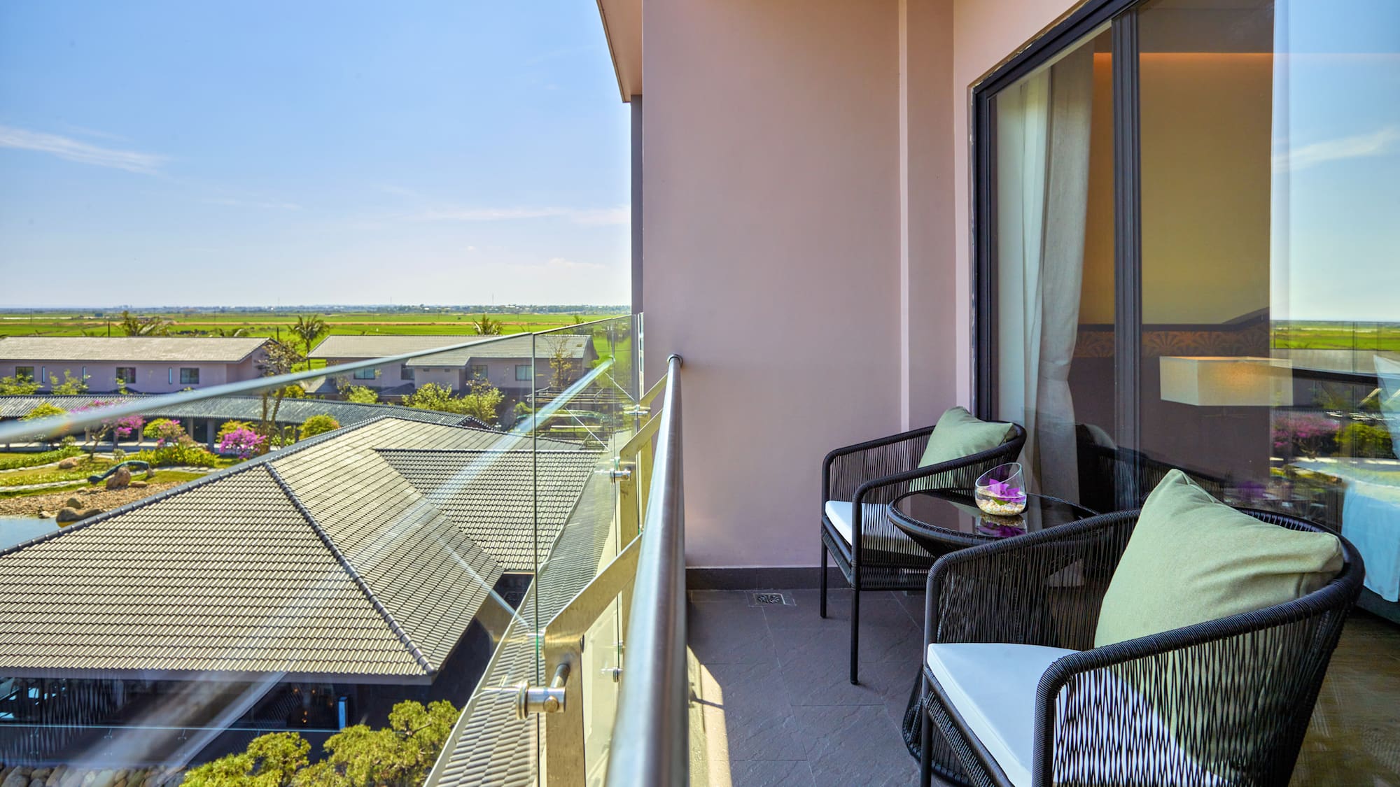 a balcony with chairs and a table