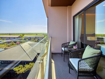 a balcony with chairs and a table