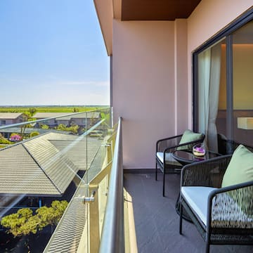 a balcony with chairs and a table