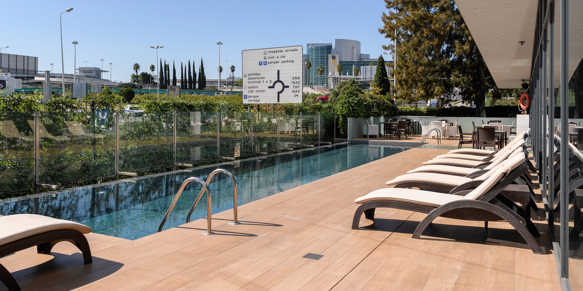 a pool with chairs and a fence