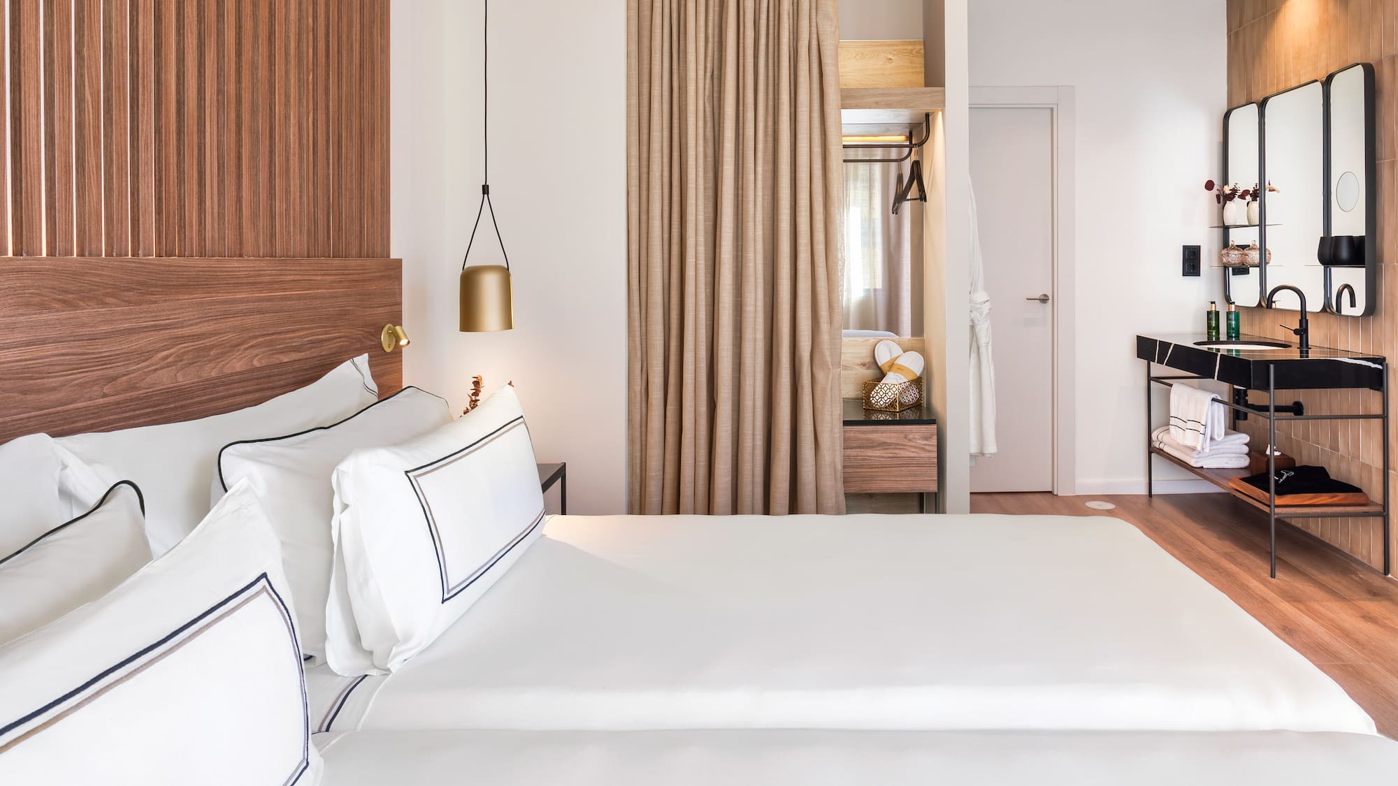 a room with two beds and a desk