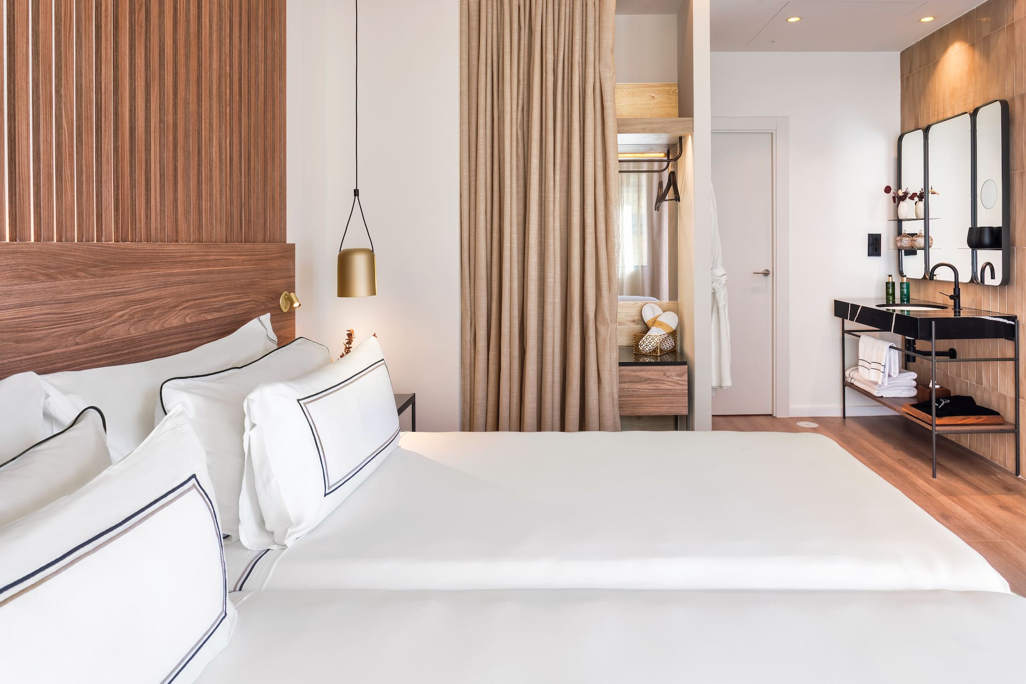 a room with two beds and a desk