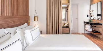 a room with two beds and a desk