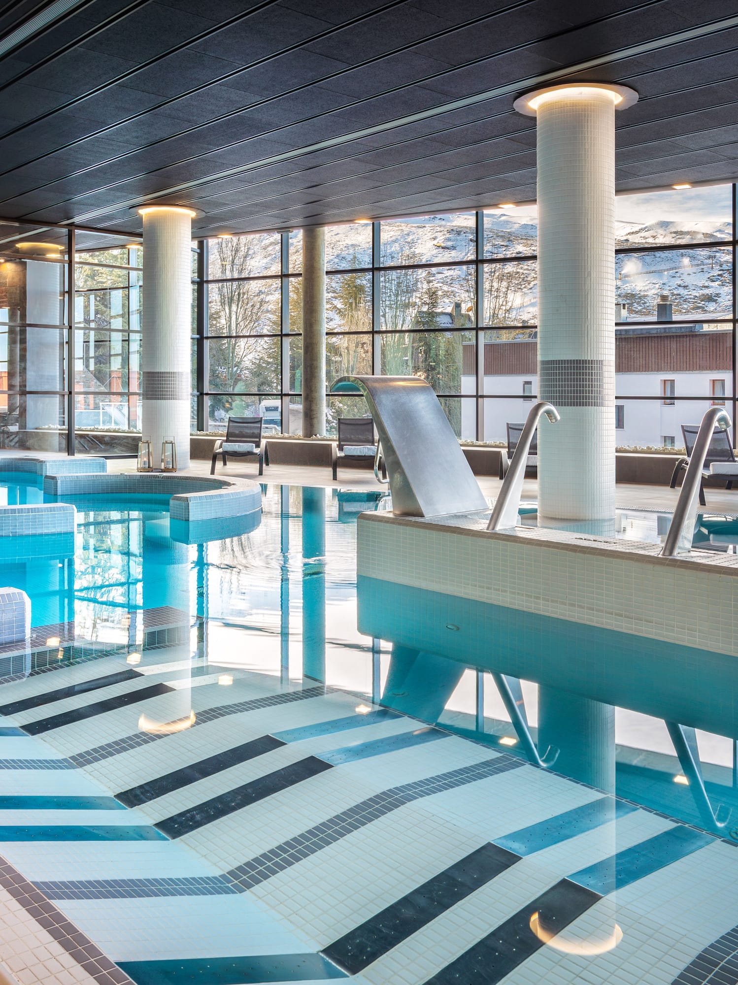 a large indoor pool with a large window