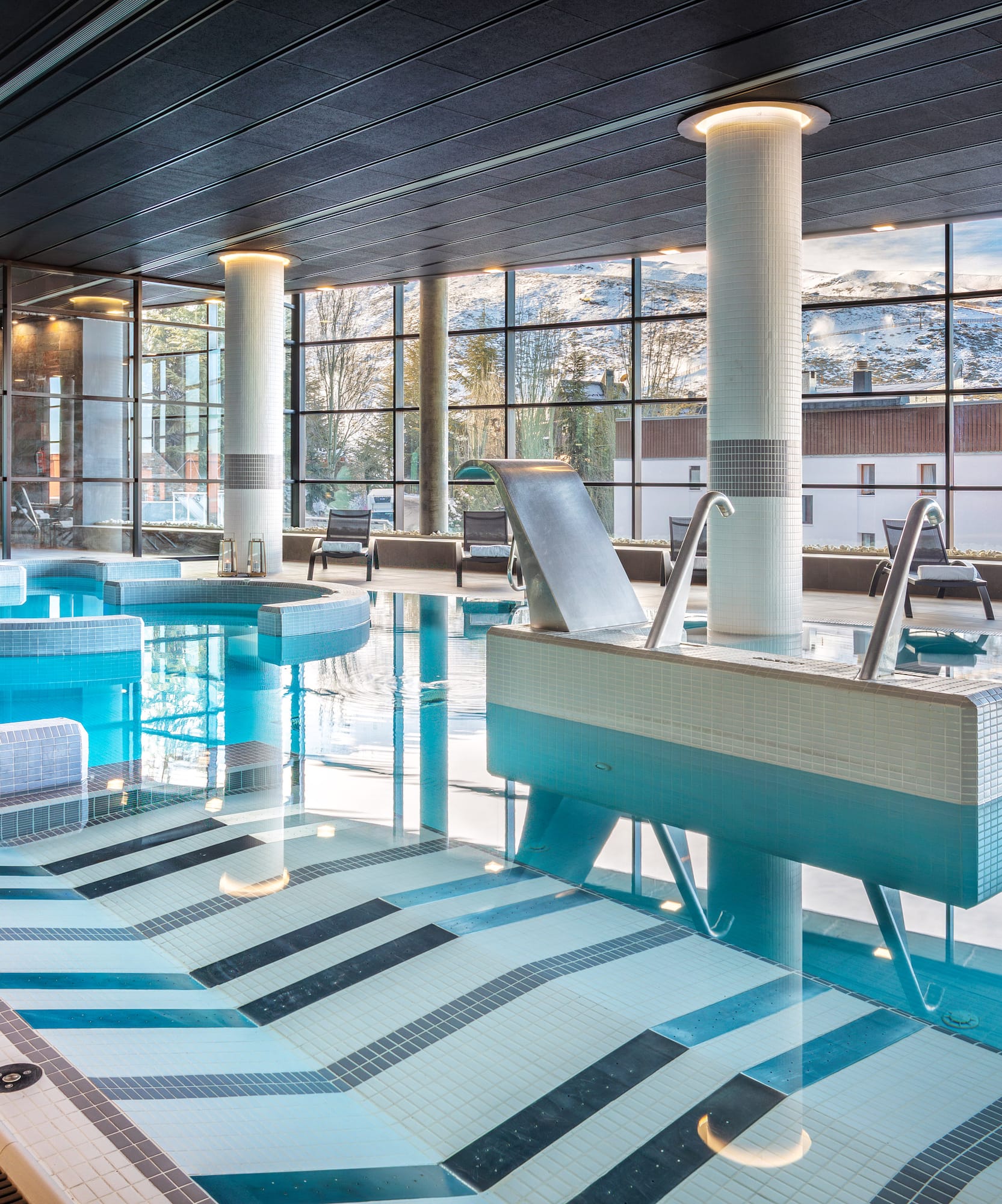 a large indoor pool with a large window