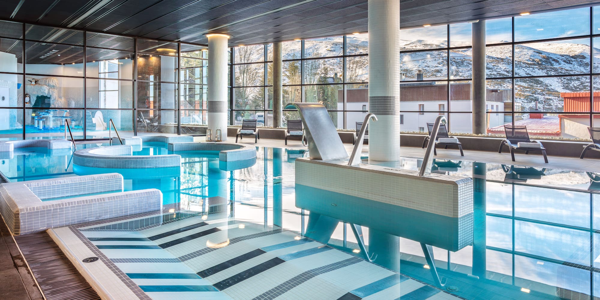 a large indoor pool with a large window