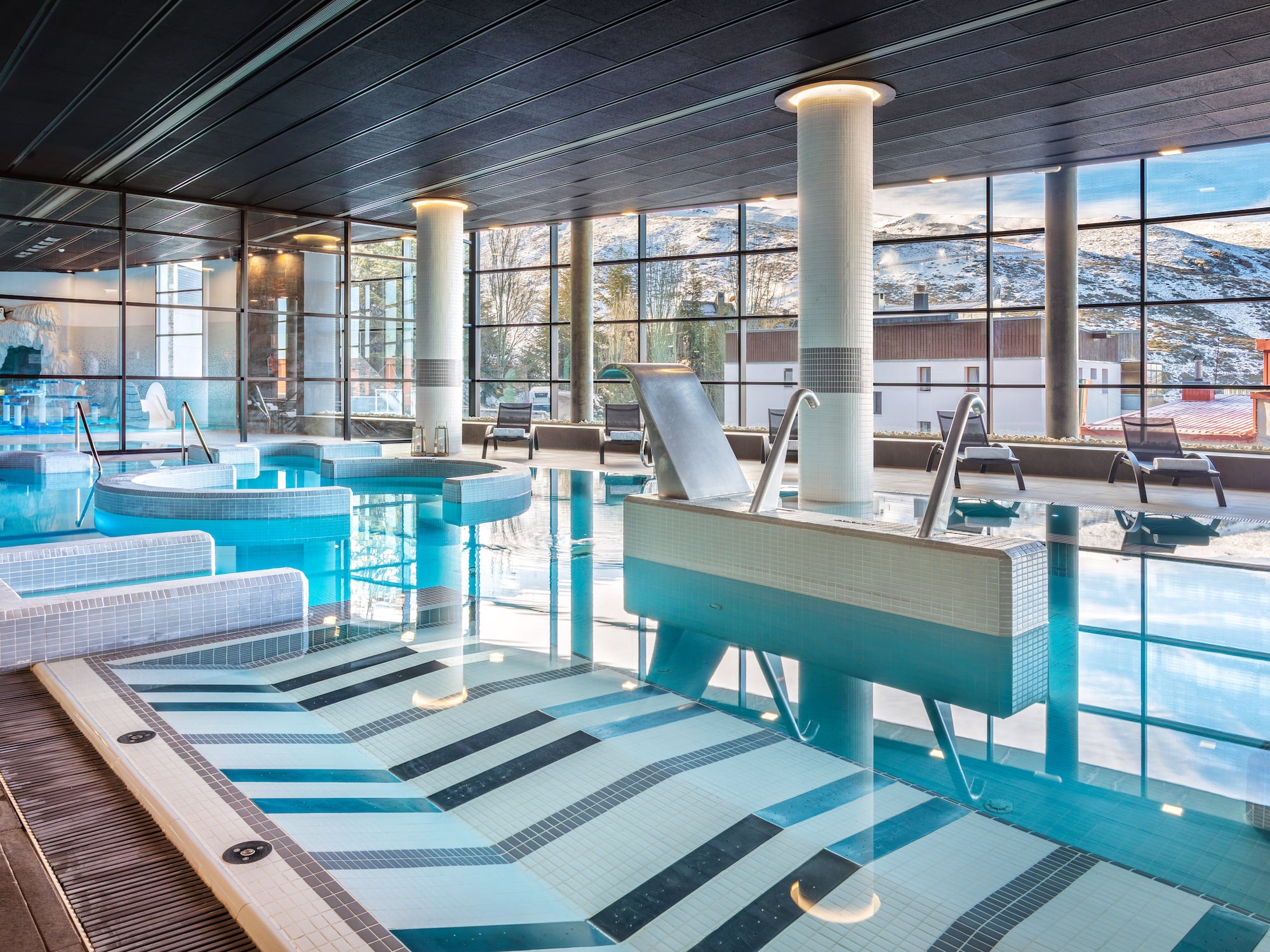 a large indoor pool with a large window