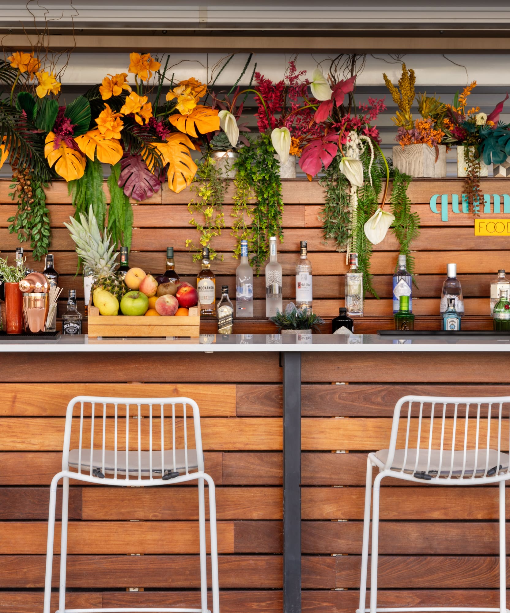 a bar with bottles and flowers