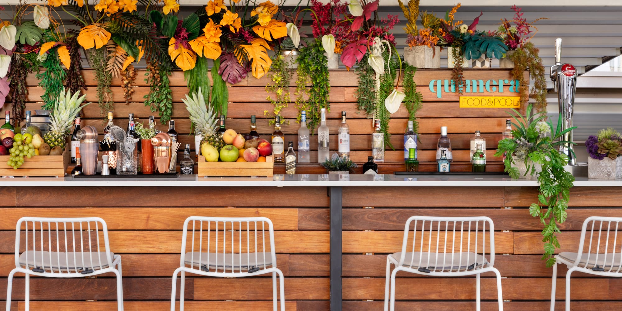a bar with bottles and flowers