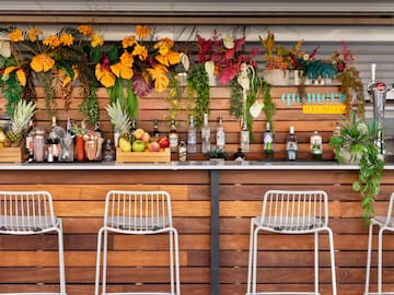 a bar with bottles and flowers