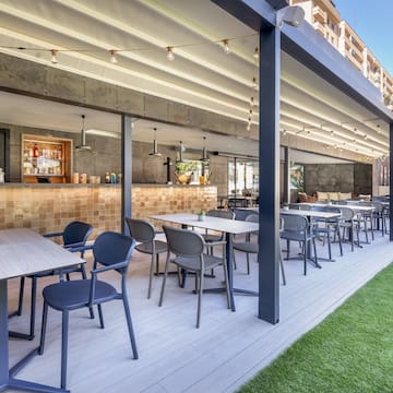 a patio with tables and chairs