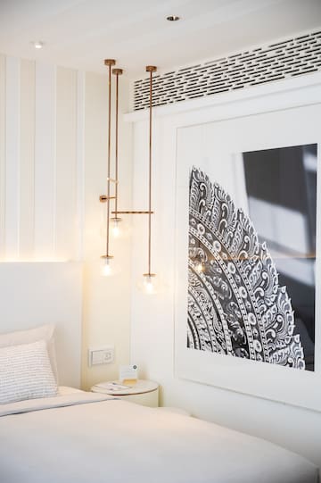a bedroom with a picture from the ceiling