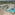Luxury beach resort with pools, sandy beach, and tropical palm trees.