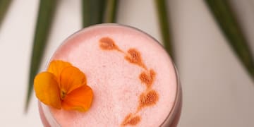 a pink drink with a flower on top
