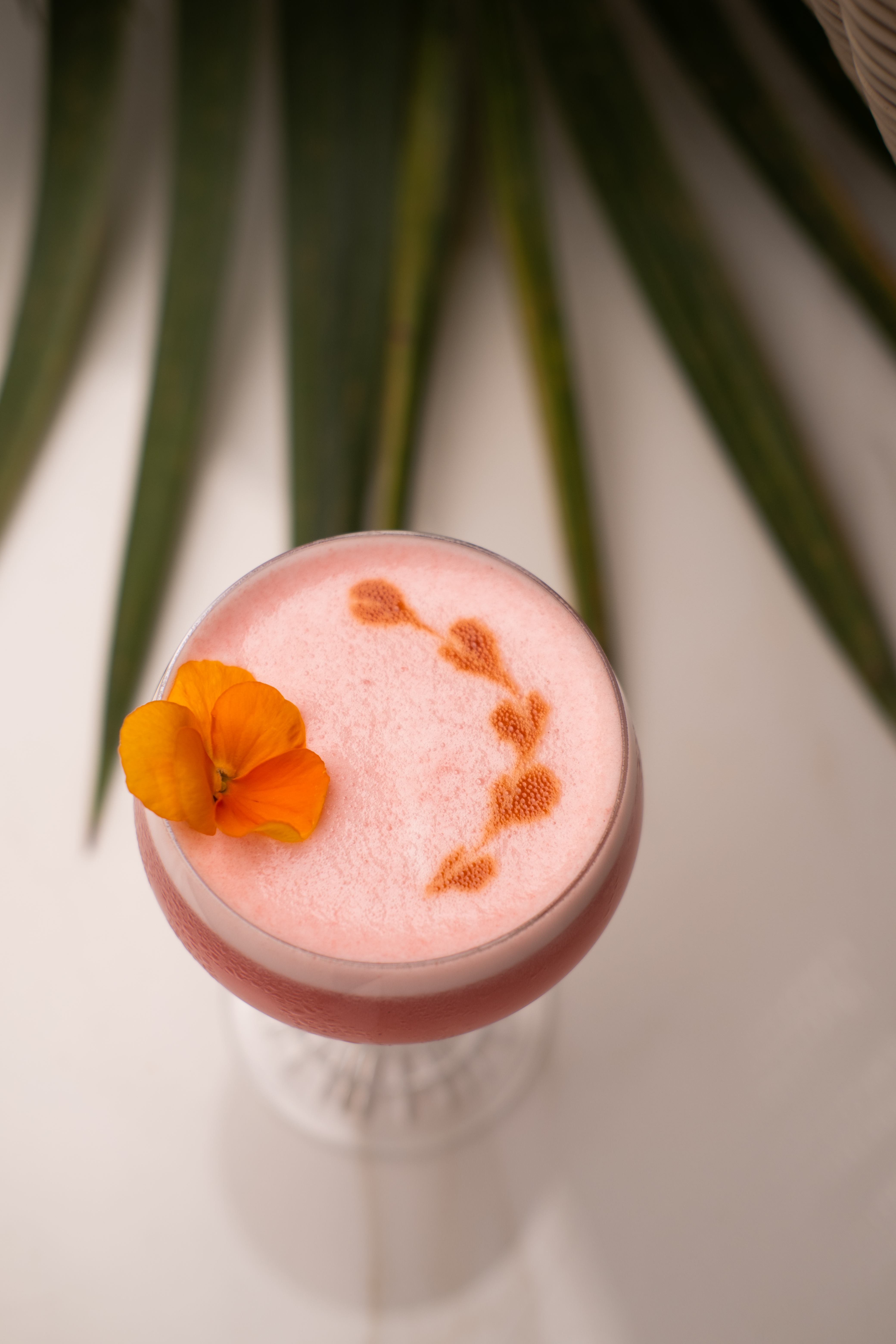 a pink drink with a flower on top