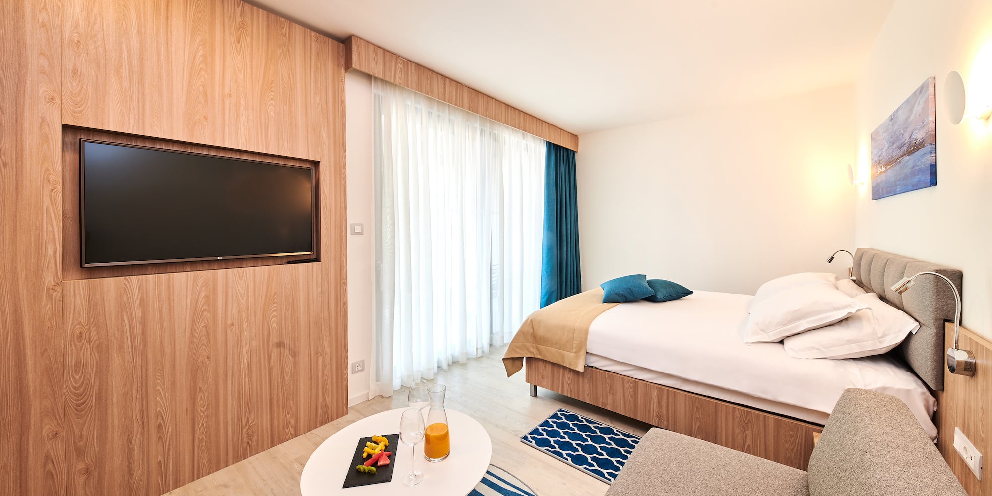 a room with a bed and a tv