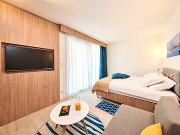 a room with a bed and a tv