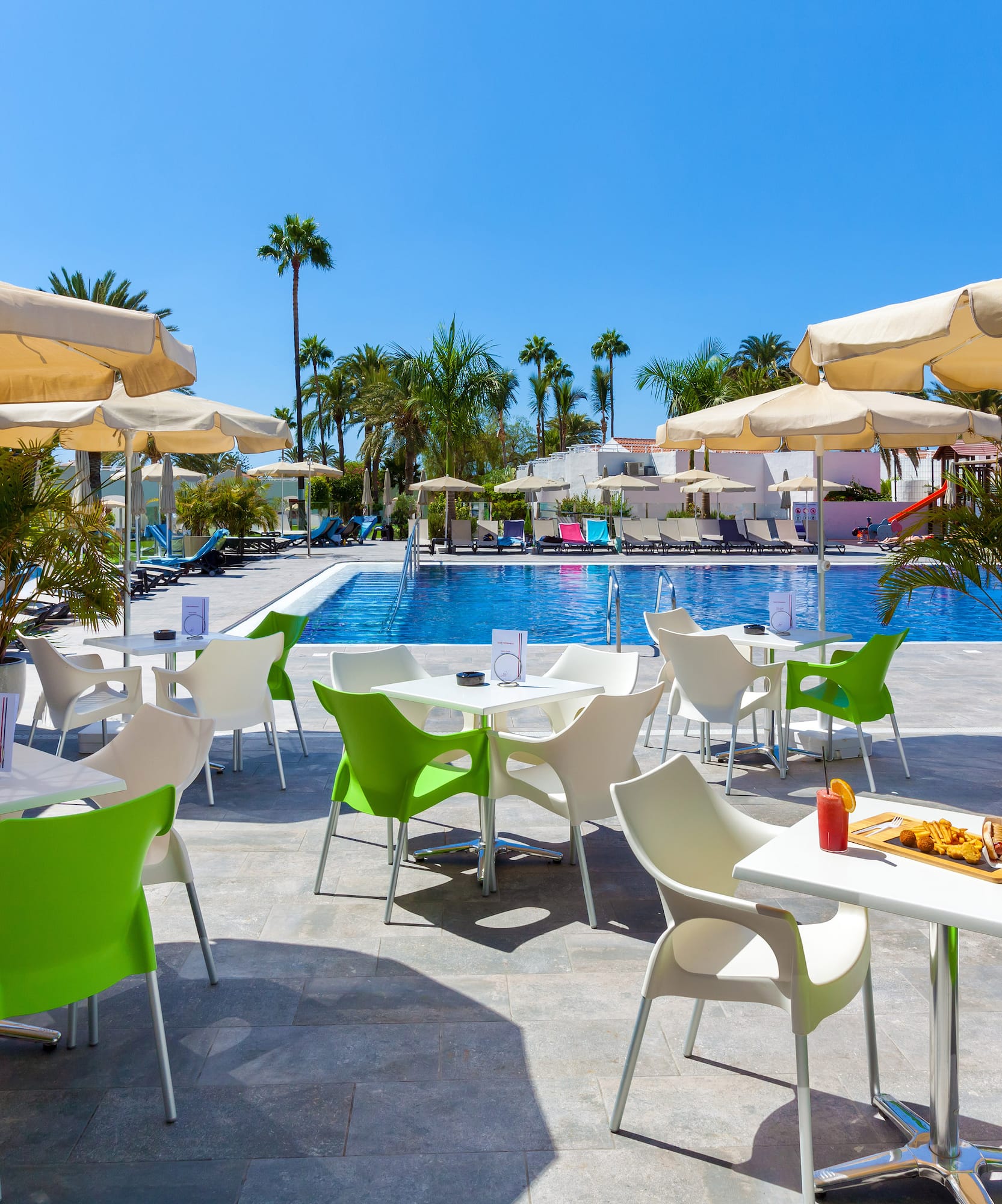 a pool with tables and chairs