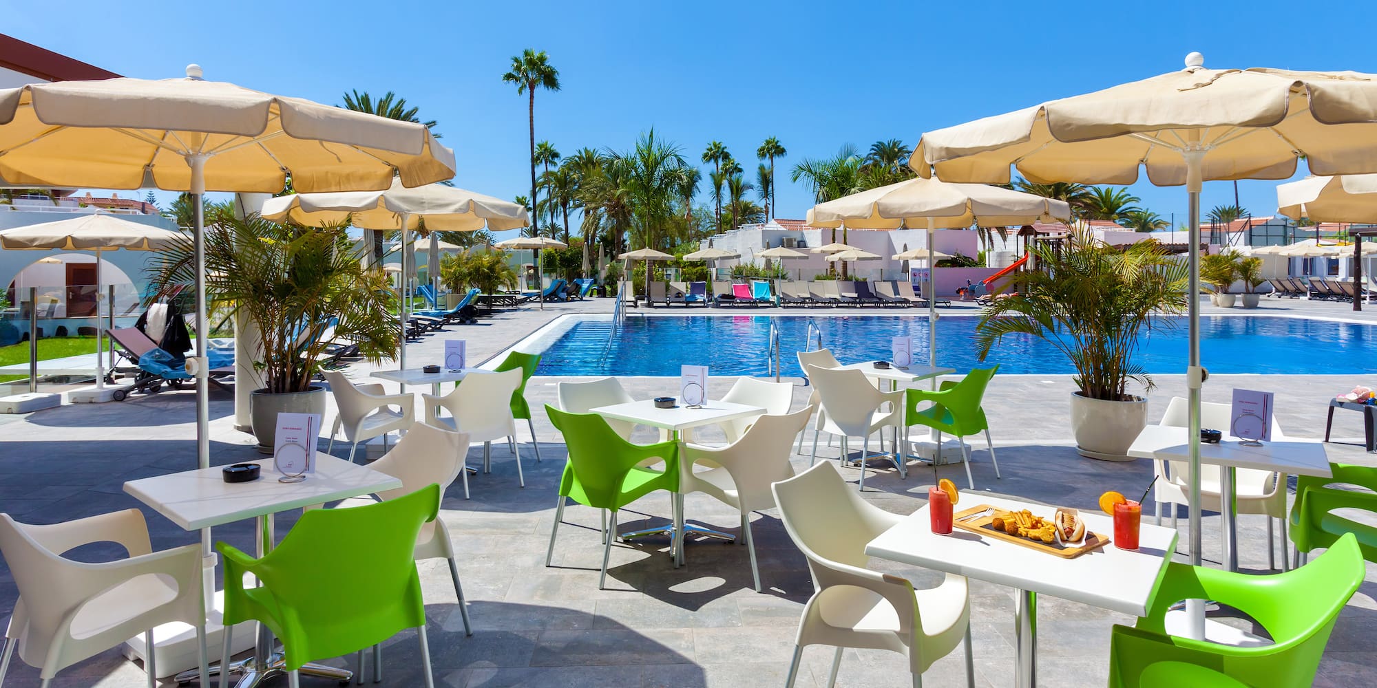 a pool with tables and chairs