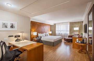 a room with a bed and desk and chair