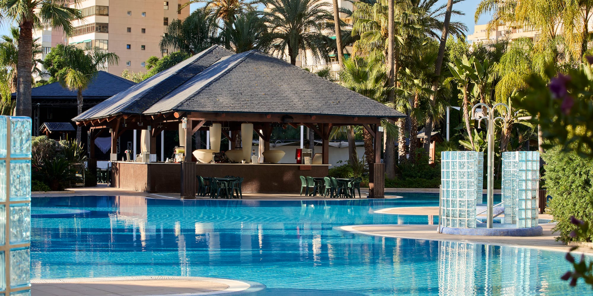a pool with a bar and chairs