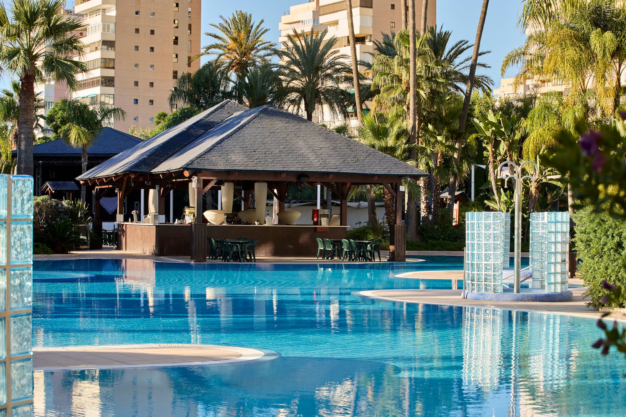 a pool with a bar and chairs