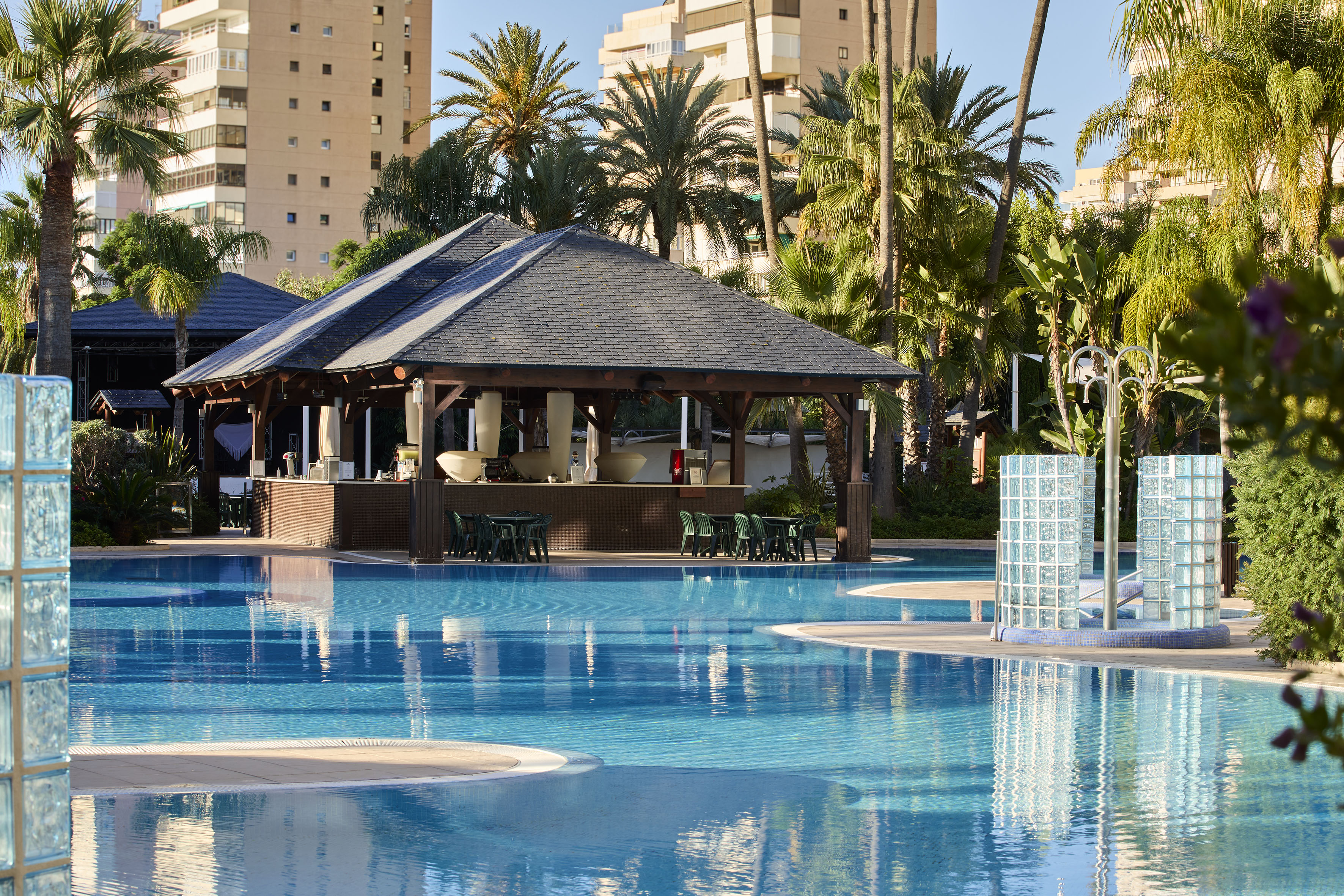 a pool with a bar and chairs
