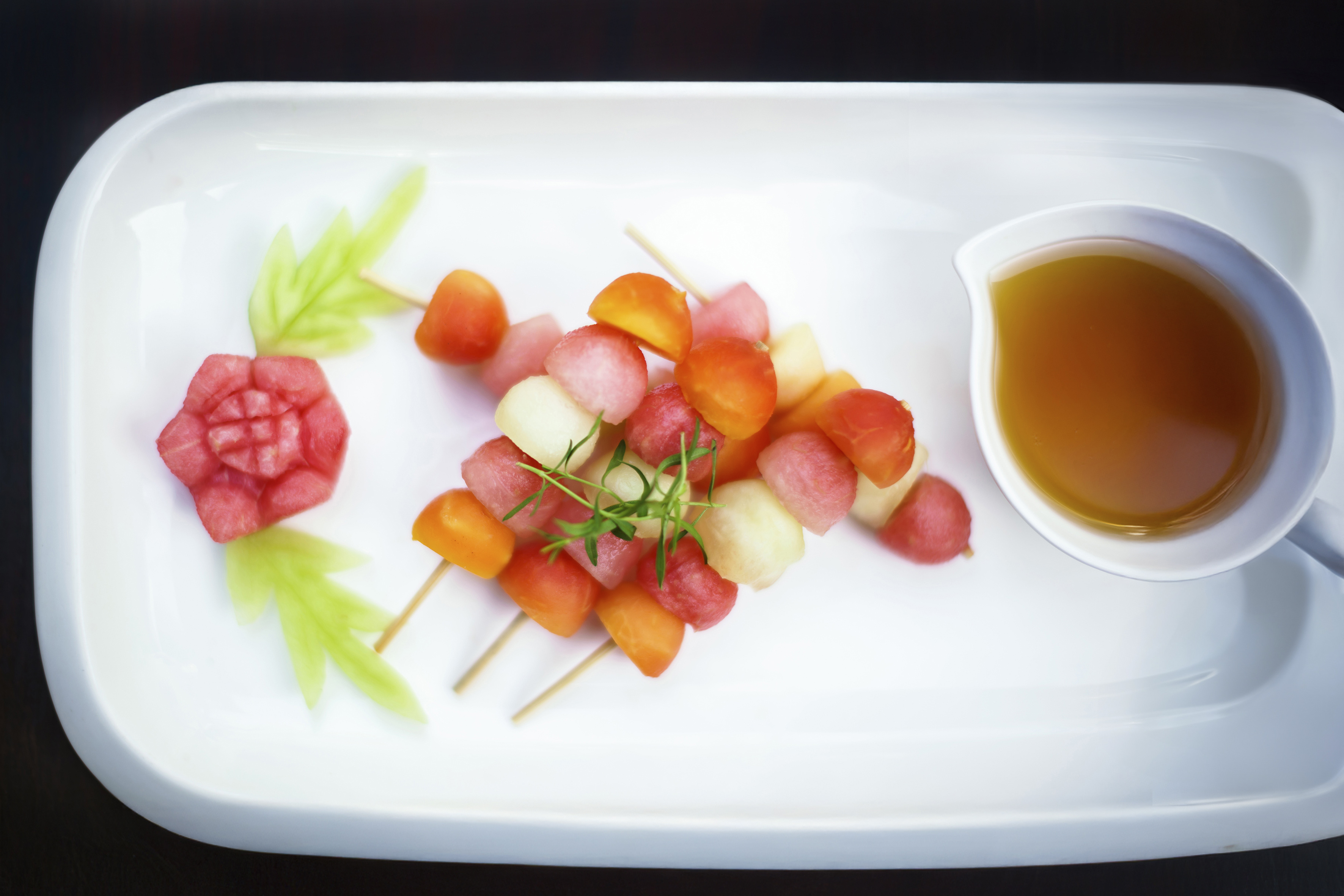 a plate of fruit and a cup of tea